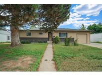 Charming single-story home with an attached garage and mature tree in a well-maintained front yard at 1231 W Radcliff Ave, Englewood, CO 80110