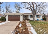 Ranch style home with brown garage door, white brick exterior, and landscaping at 551 E Caley Dr, Centennial, CO 80121