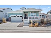 Charming home with a two-car garage, covered porch, and neat landscaping for a welcoming curb appeal at 8187 Mount Kataka St, Littleton, CO 80125