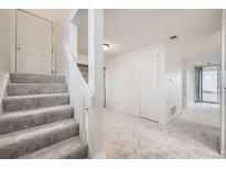 Entryway with carpeted stairs, white walls and a light gray carpeted floor at 11103 E Alameda Ave # 102, Aurora, CO 80012