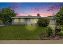 Charming ranch-style home featuring a well-manicured lawn, mature trees, and inviting curb appeal at 3058 W 134Th Way, Broomfield, CO 80020