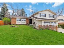 Charming two-story home features a brick accent, lush green lawn and a two car garage at 1768 E Jamison Ave, Centennial, CO 80122