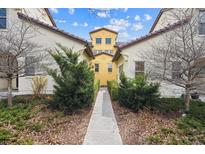 Townhouse exterior showcasing manicured bushes and a walkway leading to the entrance, with a bright blue sky overhead at 9654 Martin Luther King Jr Blvd, Denver, CO 80238