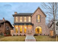 Charming two-story brick home showcasing elegant architectural details, a welcoming front porch, and well-maintained landscaping at 1968 S Washington St, Denver, CO 80210