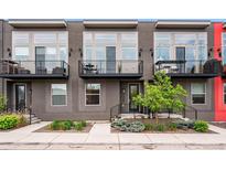 Modern townhomes with black iron railings and gray exterior paint, plus a small balcony at 3480 E 31St Ave, Denver, CO 80205