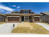 Two-story home features a 3-car garage, stone accents, covered porch and freshly landscaped front yard at 3979 Descent St, Castle Rock, CO 80108