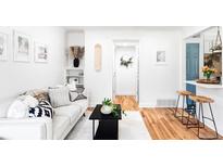 Bright living room with white walls, hardwood floors, and stylish decor throughout the open space at 2313 S Race St # A, Denver, CO 80210