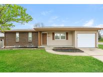 Charming single-story home featuring a brick facade and attached garage at 405 Cypress St, Broomfield, CO 80020