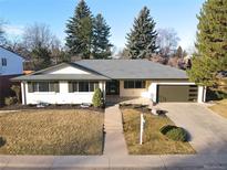Charming ranch-style home with a well-maintained lawn, mature trees, and an attached garage in a suburban setting at 2545 S Leyden St, Denver, CO 80222
