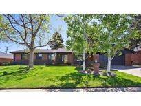 Charming brick home featuring a lush front lawn and mature trees at 2774 S Milwaukee St, Denver, CO 80210