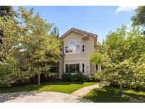 Charming two-story home with a lush green lawn and mature trees, creating a welcoming curb appeal at 1172 S Steele St, Denver, CO 80210