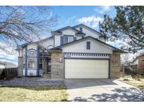 Charming two-story home with well-maintained lawn and a spacious two car garage and brick accents at 13634 Monroe St, Thornton, CO 80602