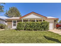 Charming single-story home with well-maintained lawn and mature front yard landscaping at 11816 Spring Dr, Northglenn, CO 80233