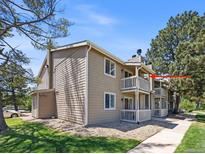 Charming two-story condo with private balconies and well-maintained landscaping at 1980 S Xanadu Way # 208, Aurora, CO 80014
