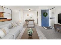 Bright living room flowing into dining area, featuring modern decor at 1980 S Xanadu Way # 208, Aurora, CO 80014