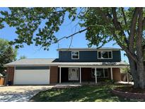 Charming two-story home with a well-manicured lawn and attached two car garage at 2122 S Zephyr St, Lakewood, CO 80227