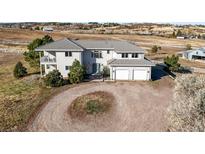 Expansive home with a neutral color palette, attached garage and private setting surrounded by beautiful scenery at 595 W Oak Hill Ln, Castle Rock, CO 80108