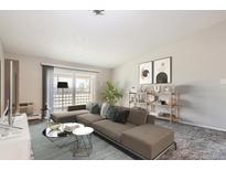 Bright living room with modern furniture and decor, flowing out to a balcony with a view at 720 S Clinton St # 2D, Denver, CO 80247