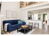 Inviting living room with a comfortable blue sofa, bright walls, and a modern aesthetic at 3026 W Prentice Ave # H, Littleton, CO 80123