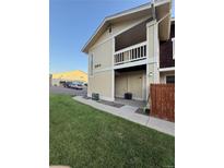 Charming home featuring a balcony and well-manicured lawn on a sunny day at 6941 W 87Th Way # 294, Arvada, CO 80003