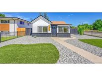 Charming home featuring stylish black and white exterior with modern rock landscaping and synthetic turf at 3064 S Galapago St, Englewood, CO 80110