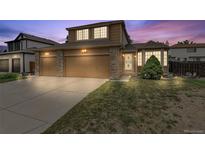 Beautiful two-story home with a three-car garage, stone accents and manicured lawn at 20651 E 42Nd Ave, Denver, CO 80249
