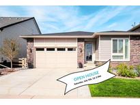 Charming single-Gathering home featuring stone accents, a two-car garage, and a well-manicured lawn at 9055 Swan River St, Littleton, CO 80125