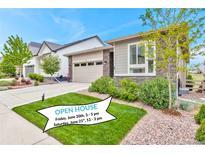 Charming single-Gathering home with a manicured lawn and an attached two-car garage and visible open house banner at 9055 Swan River St, Littleton, CO 80125