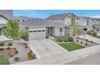 Charming single Gathering home featuring a stone facade and a well-maintained front yard with professional landscaping at 9055 Swan River St, Littleton, CO 80125