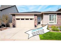 Charming single-Gathering home with a two-car garage, stone accents, and well-maintained landscaping on a sunny day at 9055 Swan River St, Littleton, CO 80125