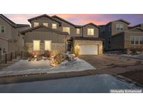 Two-story home with stone and siding accents, attached garage, and landscaping at 6922 Copper Sky Cir, Castle Pines, CO 80108