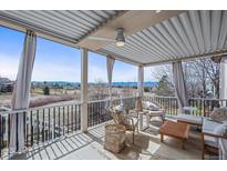 Relax on the covered patio with scenic views at 854 Countrybriar Ln, Highlands Ranch, CO 80129
