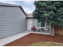 Charming home entrance with seating area and well-maintained landscaping at 17411 E Layton Dr, Aurora, CO 80015