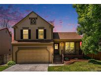 Charming two-story home with a welcoming front porch and attached two-car garage at 5310 E Manchester Dr, Castle Rock, CO 80104