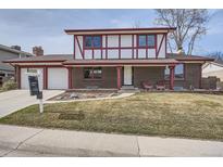 Charming two-story home with brick and tudor accents, a well-maintained lawn, and an attached two-car garage at 10321 W 102Nd Ave, Broomfield, CO 80021