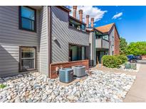 Exterior of home featuring muted siding, brick accents, and a stone garden at 12047 E Harvard Ave # 103, Aurora, CO 80014