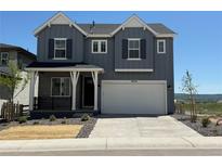 Charming two-story home featuring a two-car garage, covered porch, and modern exterior paint at 8836 Whiteclover St, Littleton, CO 80125