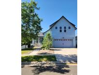 Charming two-story home with a well-maintained lawn and a spacious two-car garage at 4628 Mt Shavano St, Brighton, CO 80601