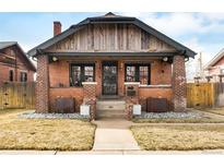 Charming brick home with a welcoming front porch and well-maintained landscaping at 1453 S Lafayette St, Denver, CO 80210