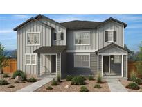 Charming new construction townhome with inviting front porch and neutral gray toned exterior at 2201 Onion Shed Aly, Brighton, CO 80601