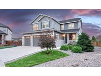 Charming two-story home boasts a well-manicured lawn, mature trees, and a welcoming front porch at 6470 Amur Ct, Castle Rock, CO 80108
