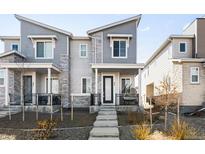 Stylish two-story townhome featuring stone accents and a covered front porch with space to relax at 47 N Uriah St, Aurora, CO 80018