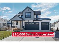 Charming two-story home featuring a three-car garage, modern farmhouse accents and manicured lawn at 39283 Hart Cir, Elizabeth, CO 80107