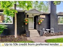 Charming entrance with black brick, front porch, and flowers, leading into a cozy home at 1218 S University Blvd, Denver, CO 80210