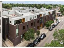 Modern townhome exterior with unique architecture, a rooftop deck, and private entrances on a tree-lined street at 3233 Tejon St # 305, Denver, CO 80211