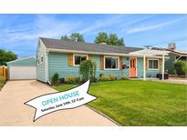 Charming single-story home featuring a well-manicured lawn, detached garage, and an eye-catching orange front door at 1892 S Meade St, Denver, CO 80219