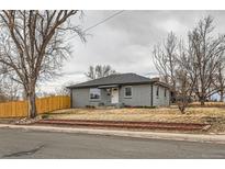 Charming single-story home with painted brick, well-maintained landscaping, and a welcoming front yard at 9295 E 12Th Ave, Aurora, CO 80010