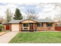 Charming brick home with a well-maintained lawn and a one car garage at 822 S Worchester St, Aurora, CO 80012
