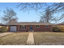 Charming brick ranch-style home with a well-manicured front yard and welcoming entrance at 3148 Victor St, Aurora, CO 80011