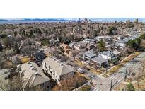 A scenic aerial view showcases the neighborhood, featuring tree-lined streets and a glimpse of the city skyline at 375 Josephine St # D, Denver, CO 80206